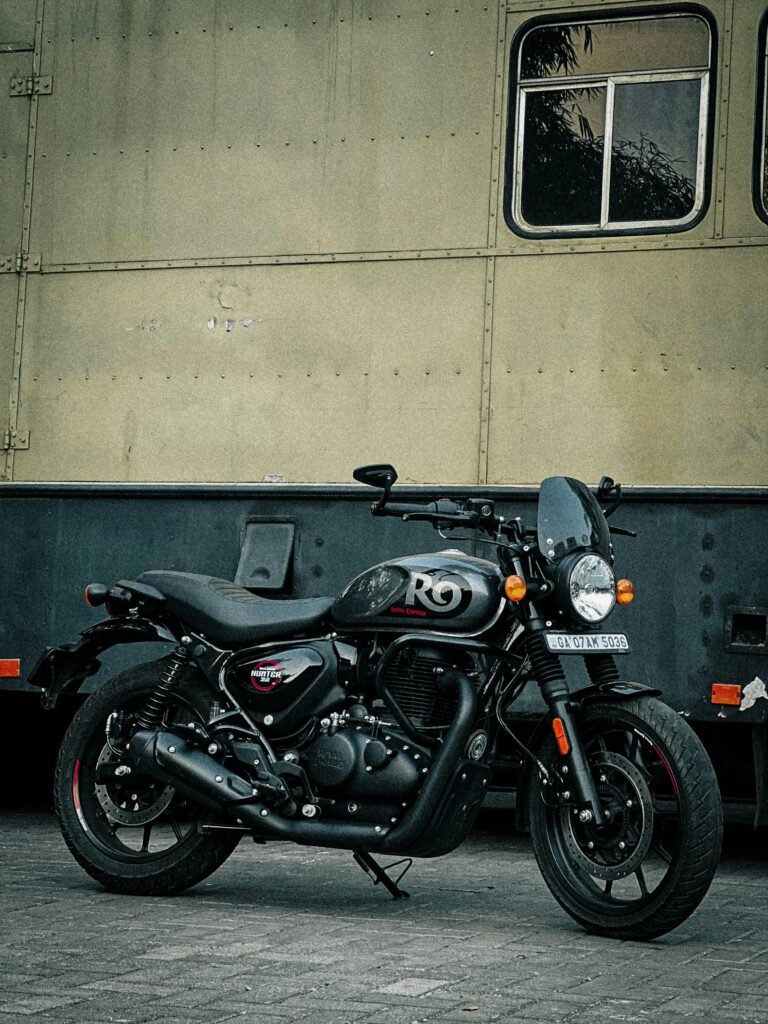 pexels-photo-31655175-31655175 Classic black motorcycle with "R9" parked in an urban industrial setting.